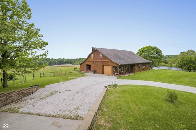 10484 N County Road 750 W, Freetown, IN 47235 - view of barn featuring gravel driveway, a water view, and an exterior structure