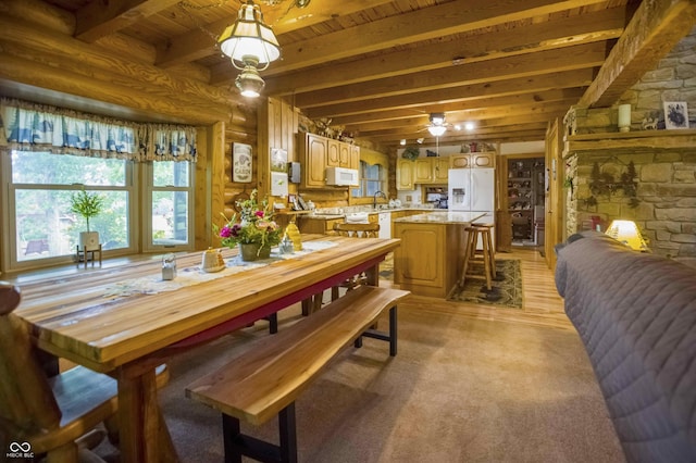 10484 N County Road 750 W, Freetown, IN 47235 - dining room featuring wooden ceiling with exposed beams, rustic walls, and light carpet
