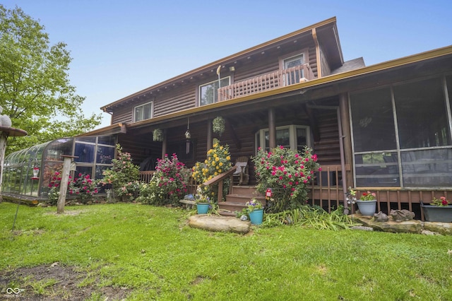 10484 N County Road 750 W, Freetown, IN 47235 - back of house featuring a sunroom and a lawn
