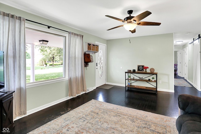 356 Daugherty St, Columbus, IN 47201 - foyer entrance with a barn door, wood-type flooring, baseboards, and ceiling fan