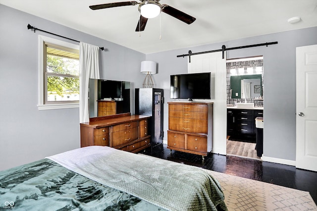 356 Daugherty St, Columbus, IN 47201 - bedroom featuring a barn door, dark wood-style flooring, and a ceiling fan