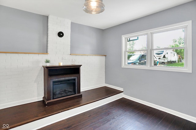 356 Daugherty St, Columbus, IN 47201 - unfurnished living room featuring a fireplace, wood finished floors, and baseboards