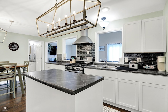 356 Daugherty St, Columbus, IN 47201 - kitchen featuring wall chimney exhaust hood, stainless steel gas range, a sink, dark countertops, and tasteful backsplash