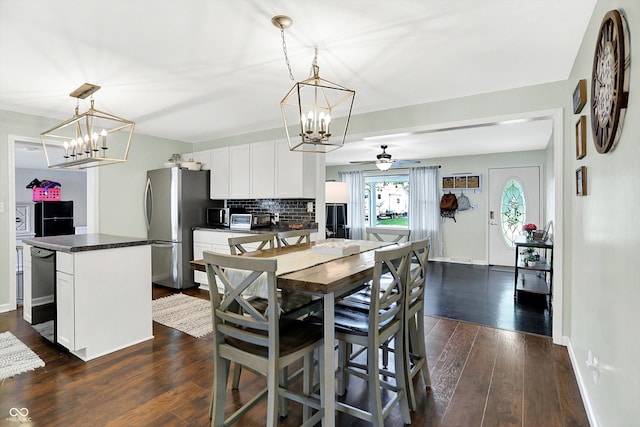 356 Daugherty St, Columbus, IN 47201 - dining area with a chandelier, ceiling fan, dark wood finished floors, and baseboards