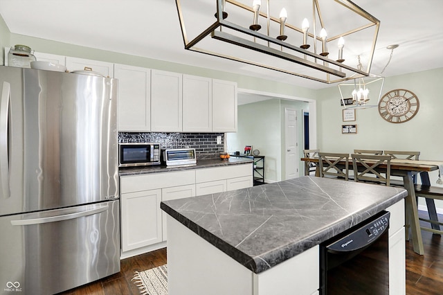 356 Daugherty St, Columbus, IN 47201 - kitchen with stainless steel appliances, dark countertops, a chandelier, dark wood-style flooring, and white cabinetry
