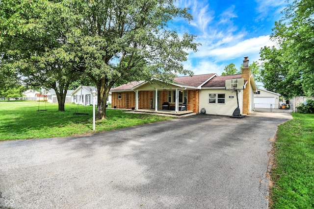 356 Daugherty St, Columbus, IN 47201 - ranch-style home featuring a porch, a front yard, a chimney, brick siding, and a detached garage