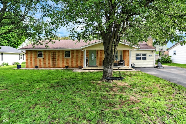 356 Daugherty St, Columbus, IN 47201 - single story home featuring covered porch, brick siding, a front lawn, and a chimney