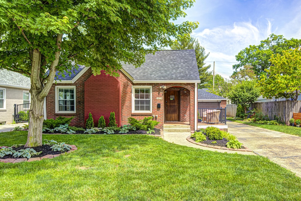 5809 N Illinois St, Indianapolis, IN 46208 - view of front facade with a shingled roof and brick siding
