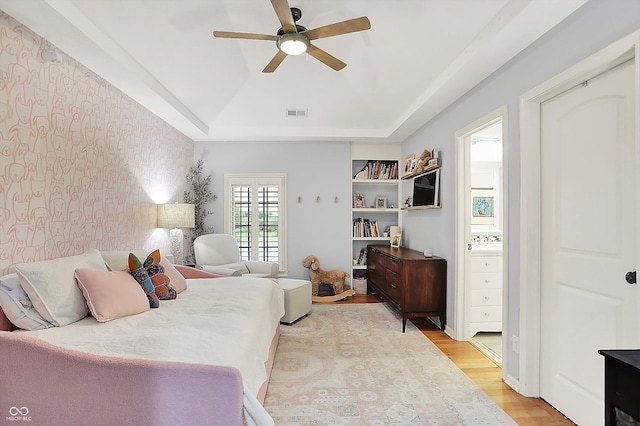 3398 Nottinghill Blvd, Plainfield, IN 46168 - bedroom with light wood-type flooring, wallpapered walls, a tray ceiling, and ceiling fan
