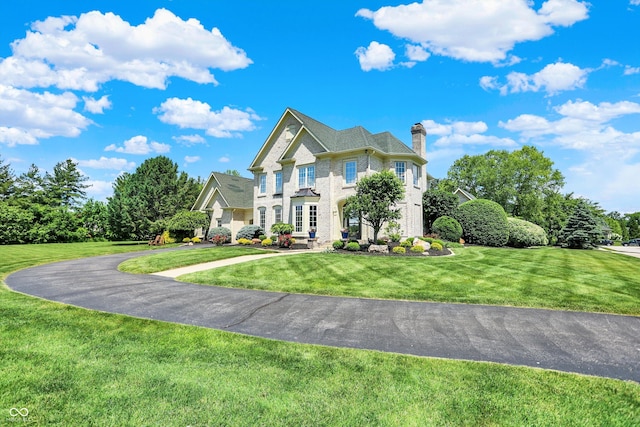 3398 Nottinghill Blvd, Plainfield, IN 46168 - view of front of property with a chimney, a front lawn, curved driveway, and brick siding