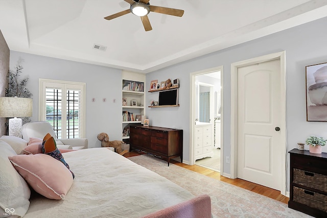 3398 Nottinghill Blvd, Plainfield, IN 46168 - bedroom featuring a tray ceiling, light wood-style flooring, ensuite bathroom, and ceiling fan