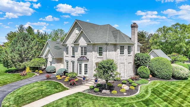 3398 Nottinghill Blvd, Plainfield, IN 46168 - view of home's exterior featuring a chimney, a yard, and brick siding