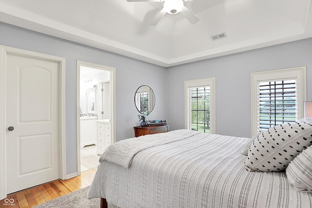 3398 Nottinghill Blvd, Plainfield, IN 46168 - bedroom featuring light wood-type flooring, connected bathroom, ceiling fan, and a raised ceiling