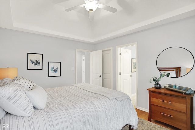 3398 Nottinghill Blvd, Plainfield, IN 46168 - bedroom featuring wood finished floors, a tray ceiling, ceiling fan, and baseboards