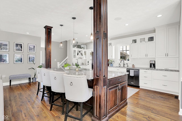 3398 Nottinghill Blvd, Plainfield, IN 46168 - kitchen with dishwasher, hardwood / wood-style floors, a kitchen breakfast bar, white cabinetry, and light stone counters