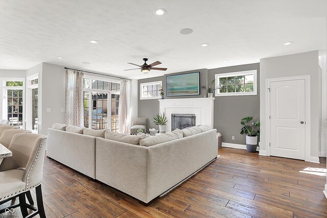 3398 Nottinghill Blvd, Plainfield, IN 46168 - living room with a fireplace, a ceiling fan, baseboards, recessed lighting, and dark wood-type flooring