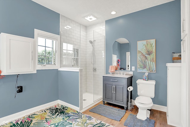 3398 Nottinghill Blvd, Plainfield, IN 46168 - full bath featuring a tile shower, toilet, vanity, baseboards, and wood finished floors