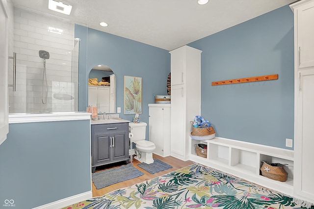 3398 Nottinghill Blvd, Plainfield, IN 46168 - bathroom with wood finished floors, vanity, tiled shower, toilet, and recessed lighting