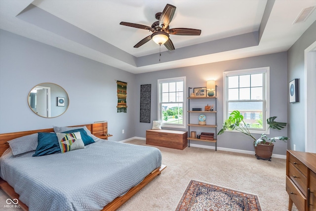 2436 Gwinnett St, Carmel, IN 46032 - bedroom with a tray ceiling, multiple windows, and baseboards