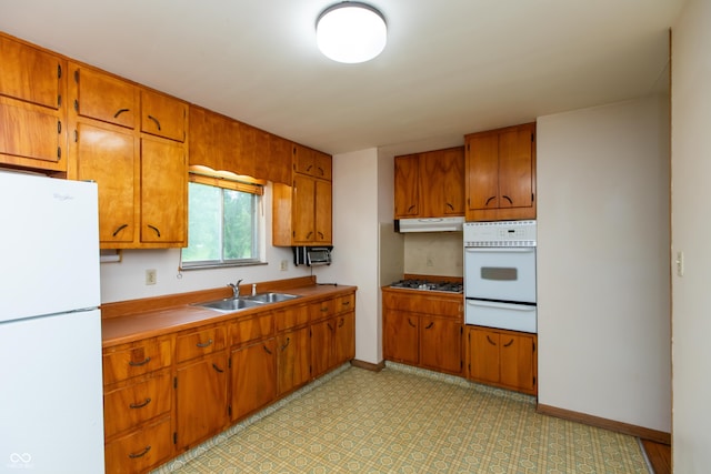 6498 N County Road 475 E, Pittsboro, IN 46167 - kitchen featuring white appliances, a sink, a warming drawer, brown cabinets, and baseboards