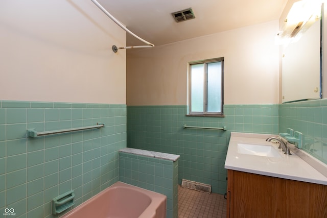 6498 N County Road 475 E, Pittsboro, IN 46167 - bathroom featuring a bathtub, vanity, wainscoting, tile patterned flooring, and tile walls