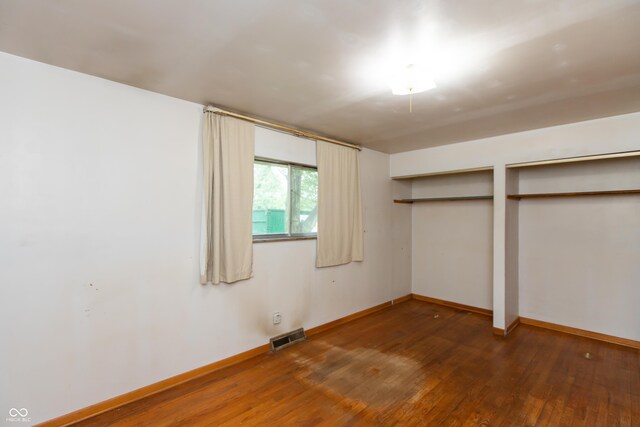 6498 N County Road 475 E, Pittsboro, IN 46167 - unfurnished bedroom with two closets, hardwood / wood-style flooring, and baseboards