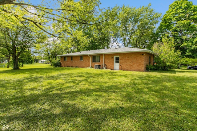 6498 N County Road 475 E, Pittsboro, IN 46167 - back of house featuring a lawn, brick siding, and cooling unit
