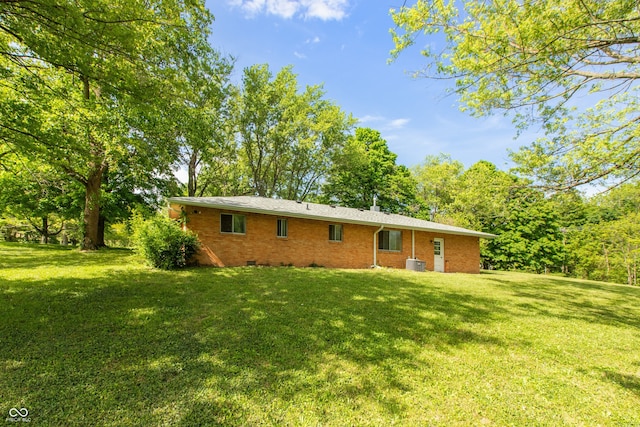 6498 N County Road 475 E, Pittsboro, IN 46167 - rear view of property with a yard, brick siding, and central AC