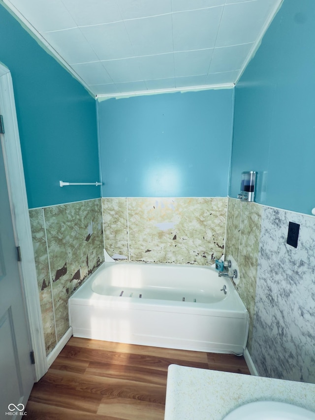 3385 W Commerce St, Vallonia, IN 47281 - full bath with a bath, wood finished floors, and wainscoting