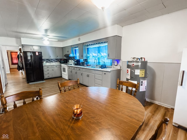 3385 W Commerce St, Vallonia, IN 47281 - dining room with electric water heater, wood finished floors, and ceiling fan