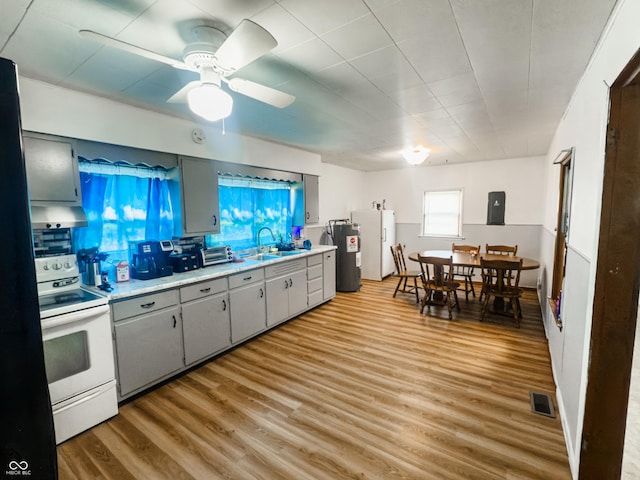 3385 W Commerce St, Vallonia, IN 47281 - kitchen featuring white range with electric stovetop, a sink, fridge, light countertops, and light wood-type flooring