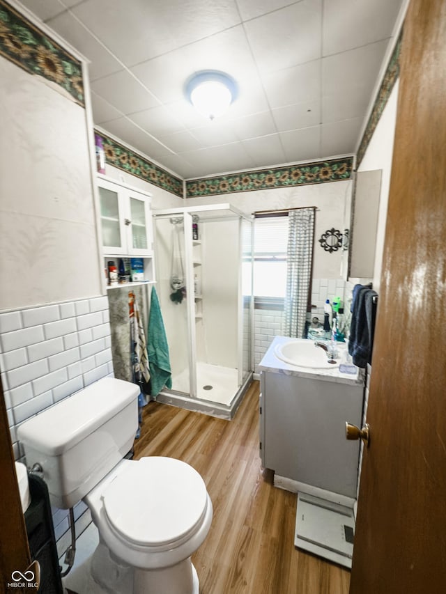 3385 W Commerce St, Vallonia, IN 47281 - full bath with wood finished floors, a stall shower, vanity, and toilet