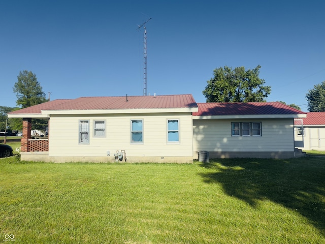 3385 W Commerce St, Vallonia, IN 47281 - back of property featuring a lawn, metal roof, and crawl space