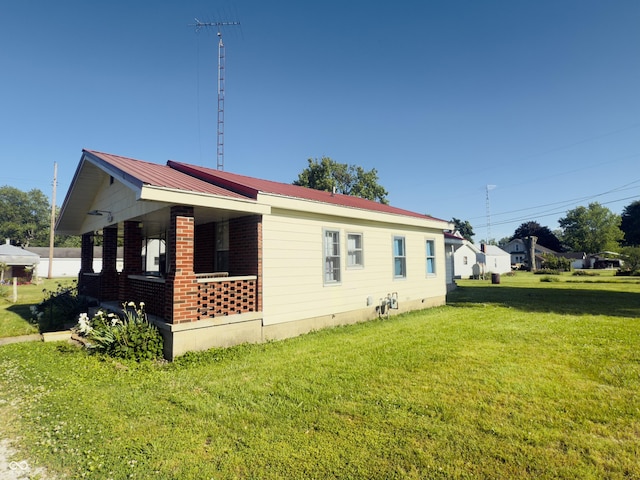 3385 W Commerce St, Vallonia, IN 47281 - view of property exterior with a lawn, crawl space, a porch, and metal roof