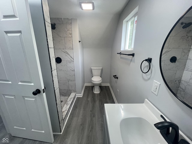 2911 E 35th St, Indianapolis, IN 46218 - full bathroom with tiled shower, toilet, a sink, wood finished floors, and baseboards