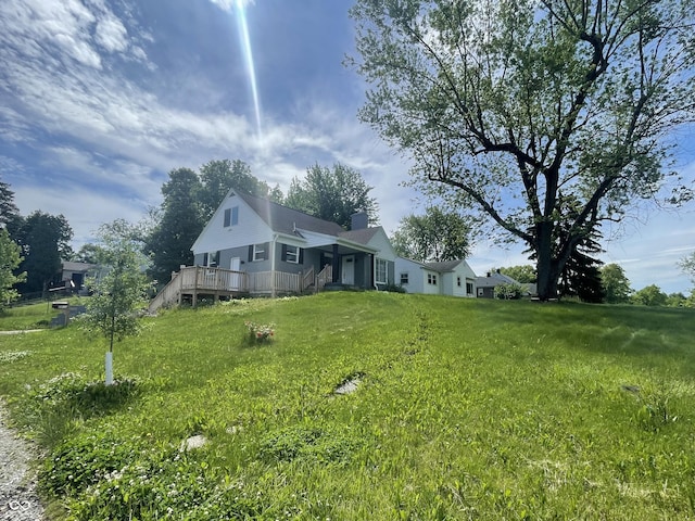 2911 E 35th St, Indianapolis, IN 46218 - view of property exterior featuring a chimney, a deck, and a yard