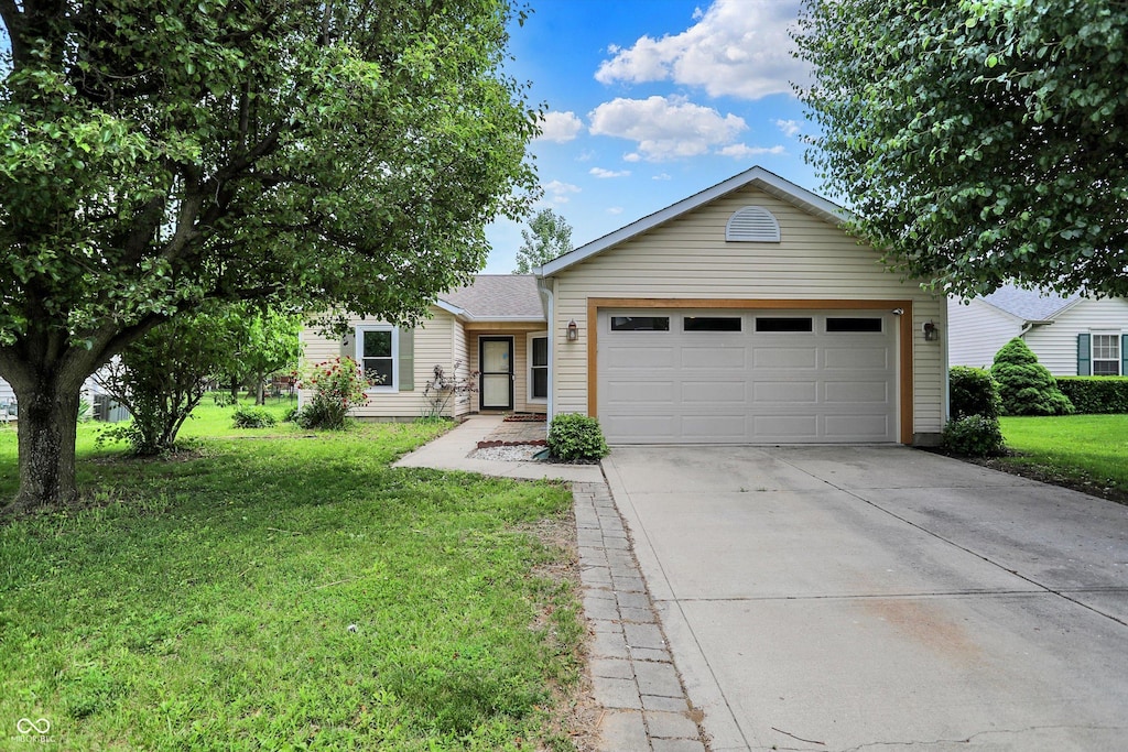 7061 Blankenship Ave, Indianapolis, IN 46217 - single story home featuring driveway, an attached garage, and a front lawn