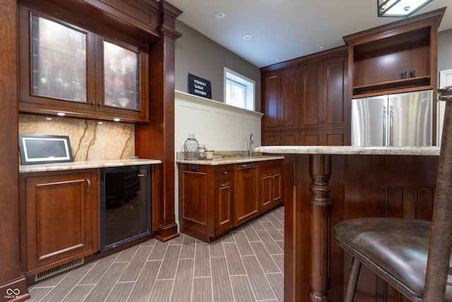 876 Box Turtle Ct, Columbus, IN 47201 - indoor bar with freestanding refrigerator, beverage cooler, tasteful backsplash, and a decorative wall