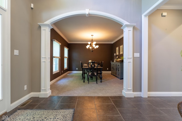 876 Box Turtle Ct, Columbus, IN 47201 - dining area featuring dark colored carpet, ornamental molding, arched walkways, a chandelier, and ornate columns