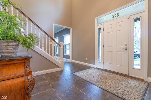 876 Box Turtle Ct, Columbus, IN 47201 - entrance foyer featuring baseboards, a high ceiling, and stairs