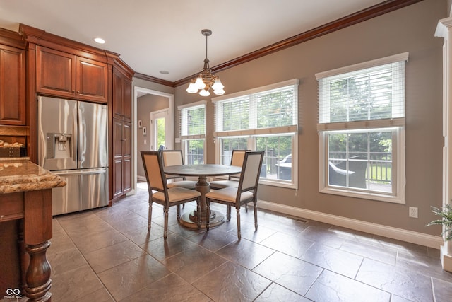 876 Box Turtle Ct, Columbus, IN 47201 - dining area featuring baseboards, healthy amount of natural light, ornamental molding, a chandelier, and stone tile flooring