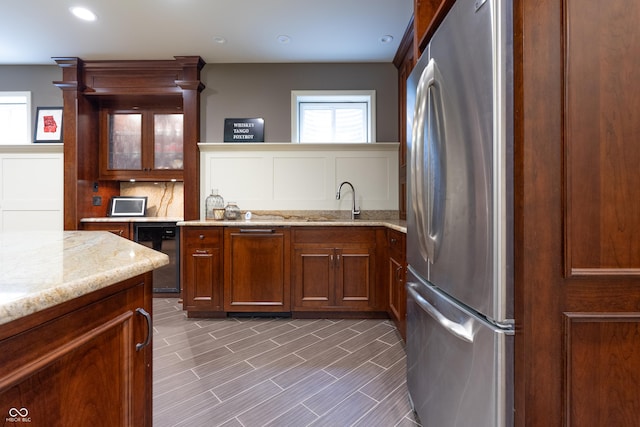 876 Box Turtle Ct, Columbus, IN 47201 - kitchen with freestanding refrigerator, wine cooler, healthy amount of natural light, light stone counters, and recessed lighting