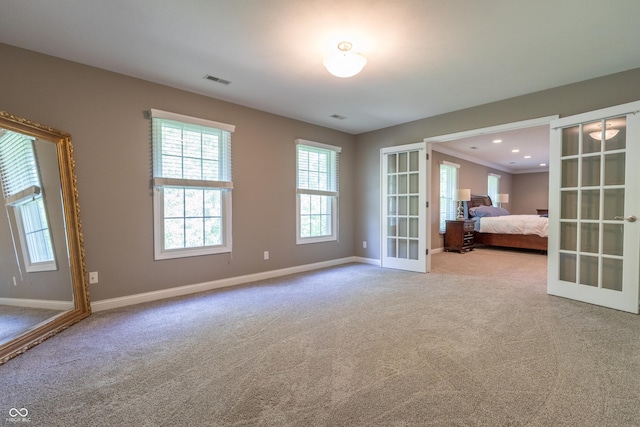 876 Box Turtle Ct, Columbus, IN 47201 - unfurnished bedroom with french doors, carpet flooring, and baseboards