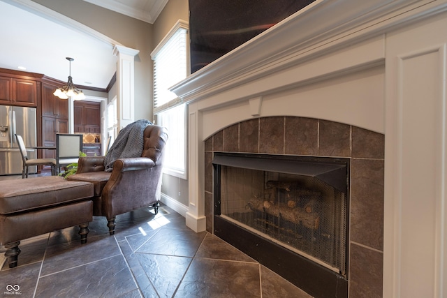 876 Box Turtle Ct, Columbus, IN 47201 - detailed view of stainless steel fridge, a tile fireplace, crown molding, baseboards, and a chandelier