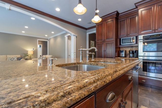 876 Box Turtle Ct, Columbus, IN 47201 - kitchen with appliances with stainless steel finishes, recessed lighting, a sink, decorative columns, and stone counters