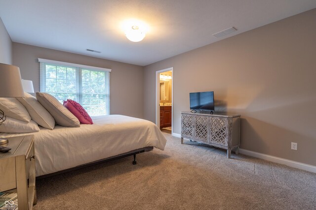 876 Box Turtle Ct, Columbus, IN 47201 - carpeted bedroom with baseboards and connected bathroom