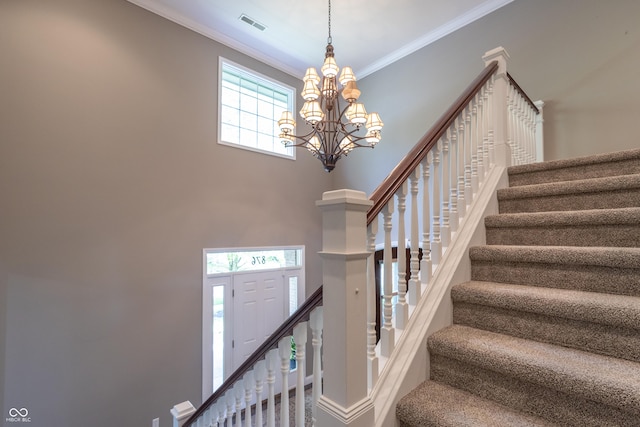 876 Box Turtle Ct, Columbus, IN 47201 - stairway featuring crown molding, a chandelier, and a towering ceiling