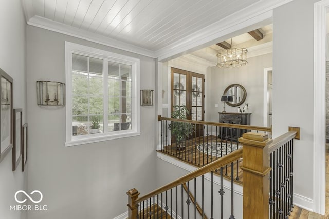 7648 Killarney Dr, Indianapolis, IN 46217 - hall with an upstairs landing, a chandelier, baseboards, ornamental molding, and wood finished floors