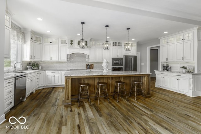 7648 Killarney Dr, Indianapolis, IN 46217 - kitchen with stainless steel appliances, a sink, a center island, white cabinets, and dark wood-style floors