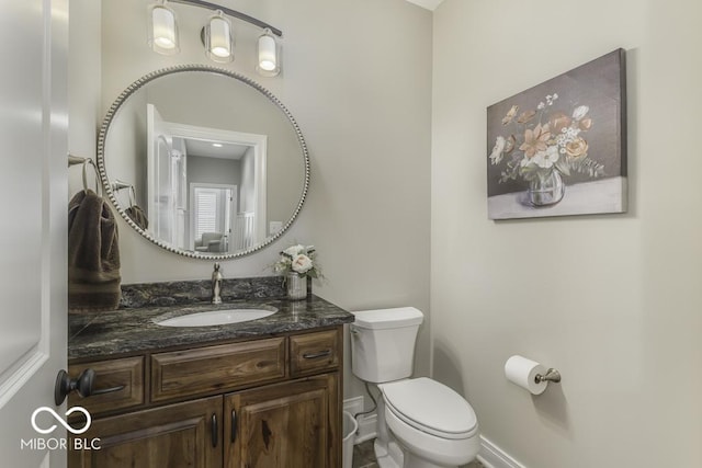 7648 Killarney Dr, Indianapolis, IN 46217 - bathroom featuring toilet, vanity, and baseboards
